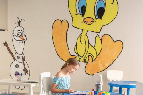 Kinds playing area with tables and wall paintings at Louis Paphos Breeze