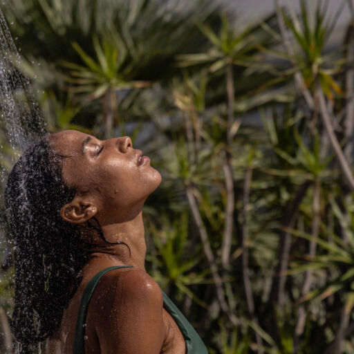 Woman enjoying shower in garden setting
