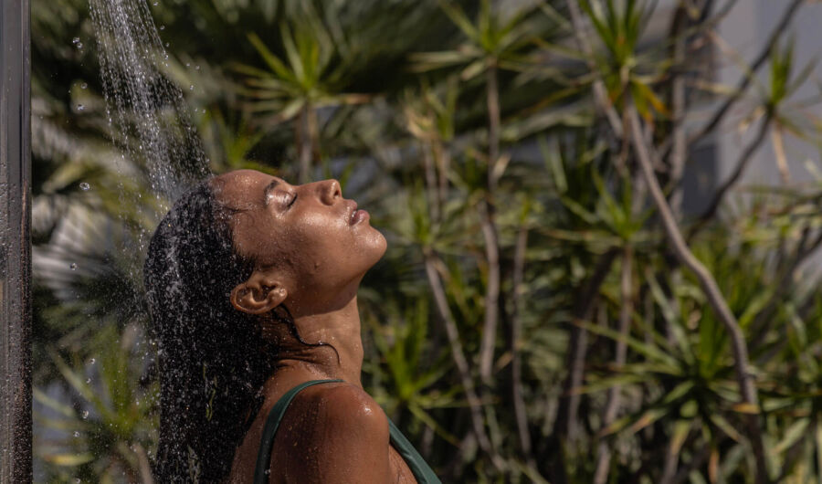 Woman enjoying shower in garden setting