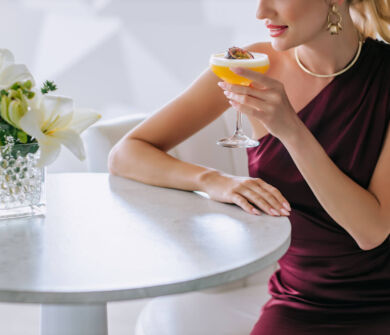Woman drinking cocktail at Ivi Mare Mirrors Bar