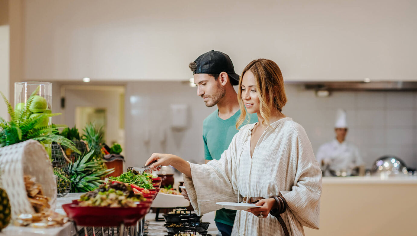 Couple taking food from the buffet at Paphos Rigani Restaurant