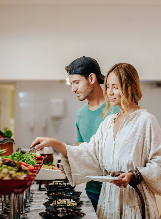 Couple taking food from the buffet at Paphos Rigani Restaurant
