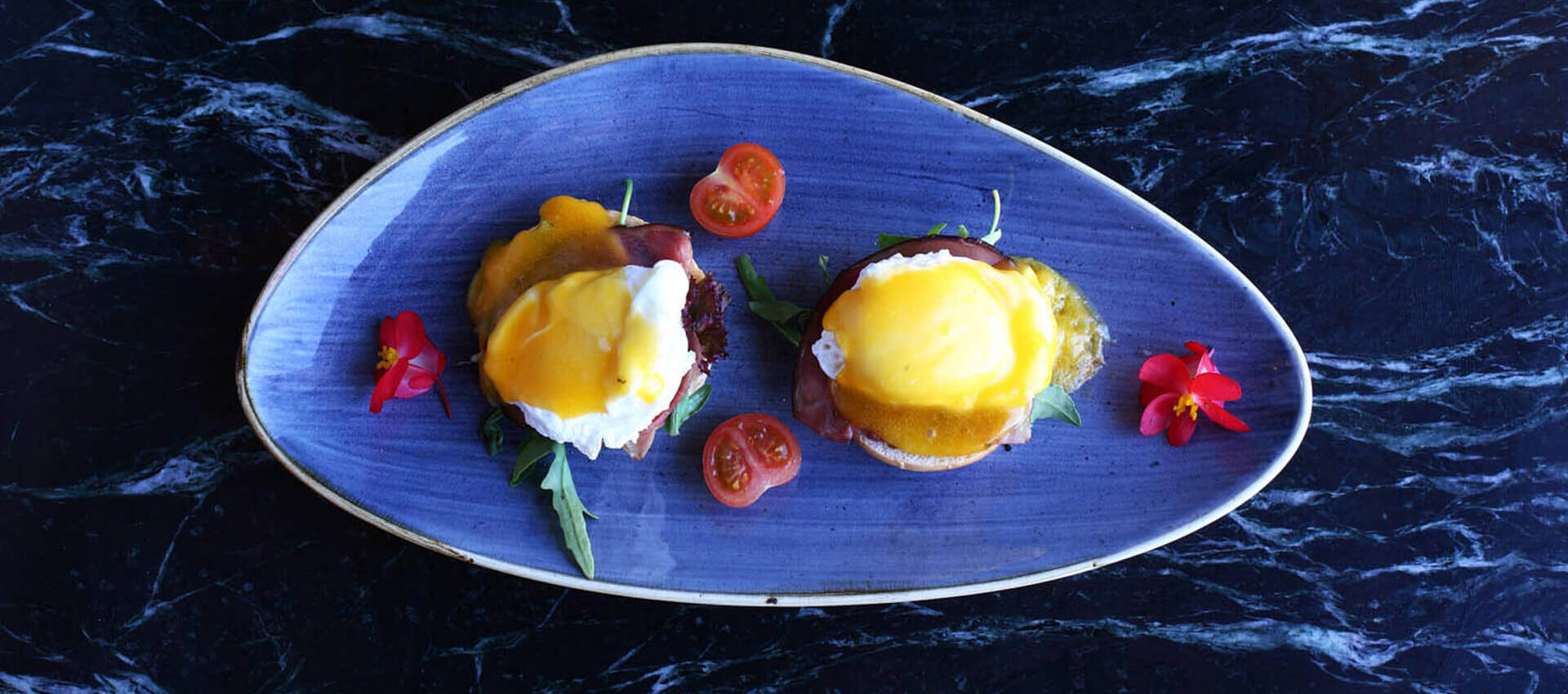 Moden egg dish plated on an oval blue dish