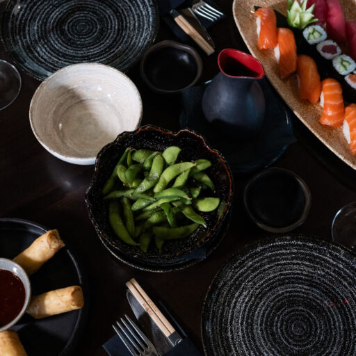 Table full Asian plated dishes and wine at Polis 1907