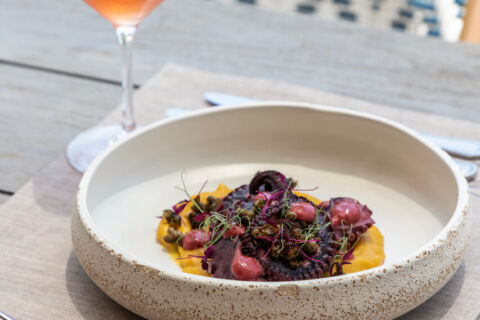 Dish octopus and wine at Royal Apollonia Alati restaurant
