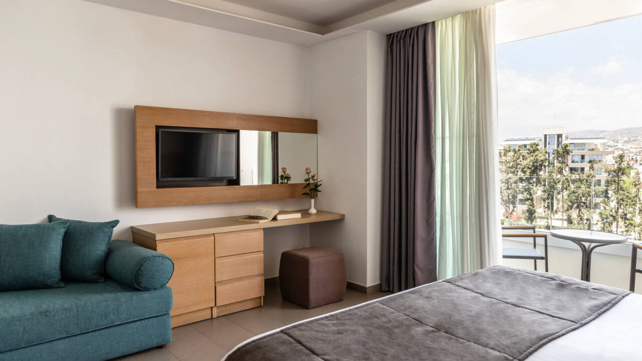 Royal Apollonia Deluxe room bedroom and balcony