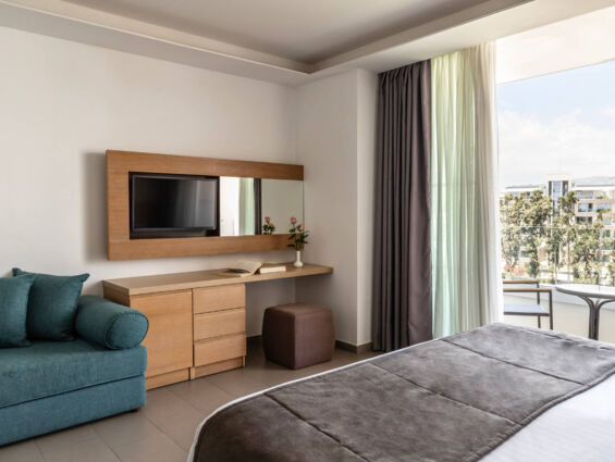 Royal Apollonia Deluxe room bedroom and balcony