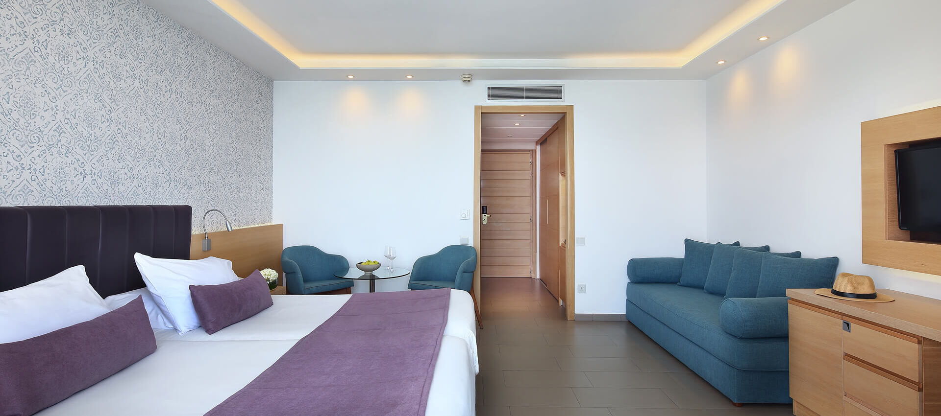 Royal Apollonia Deluxe room bedroom and entrance