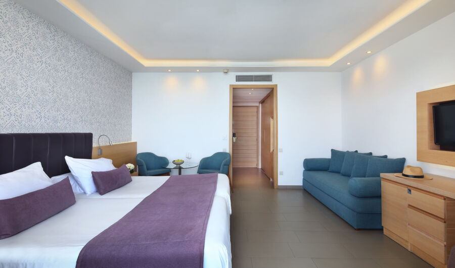 Royal Apollonia Deluxe room bedroom and entrance