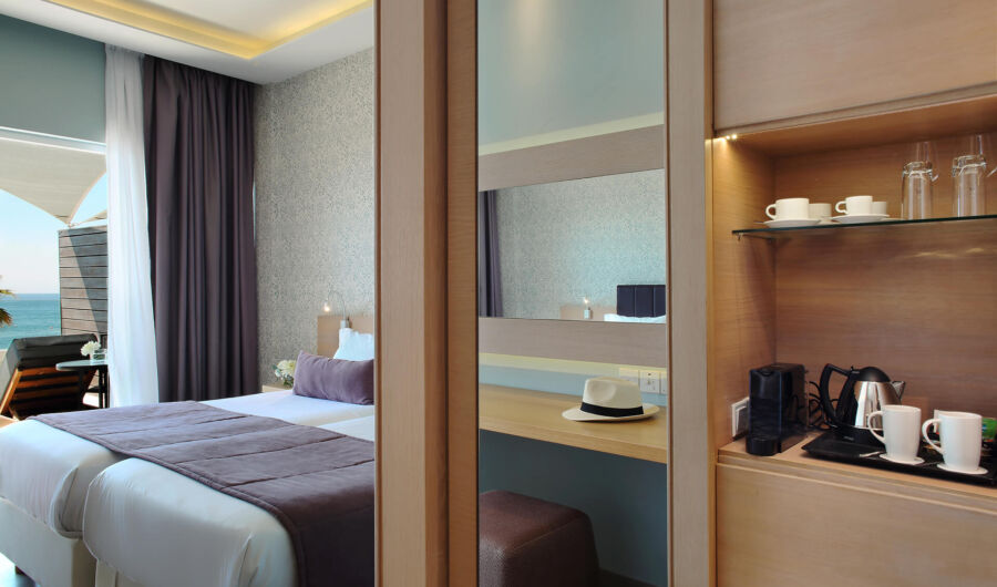 Royal Apollonia Deluxe room bedroom entrance with modern design