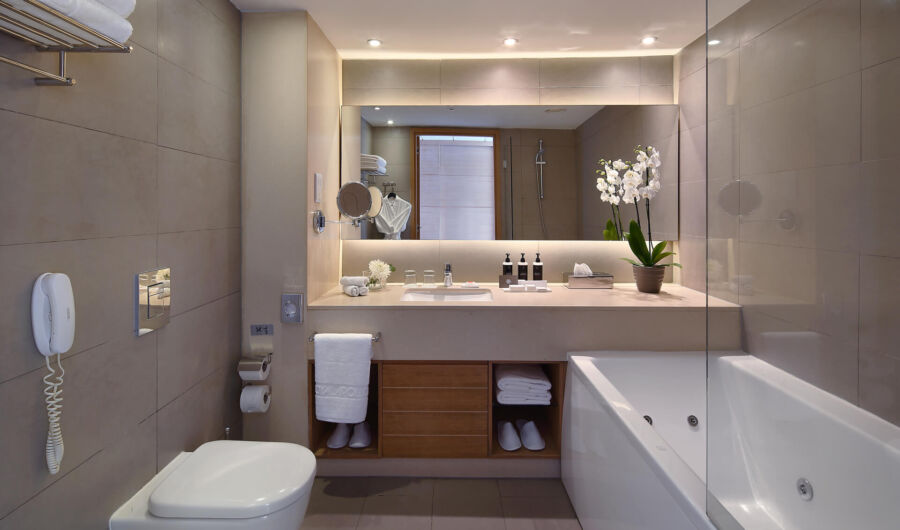 Royal Apollonia Deluxe room bedroom and bathroom