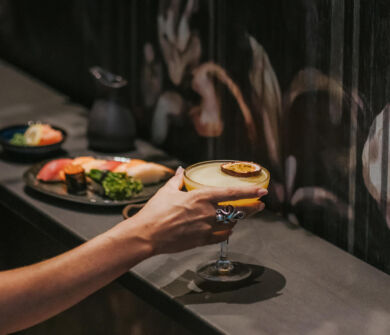 Woman Drinking coktail and having a dish of sushi at Royal Apollonia restaurant