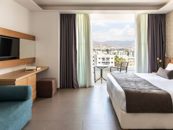Royal Apollonia Family room bedroom and sitting area with balcony with city view