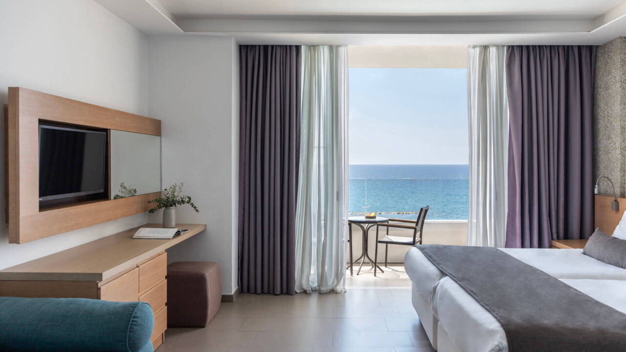 Royal Apollonia Family room bedroom and sitting area with balcony with sea view