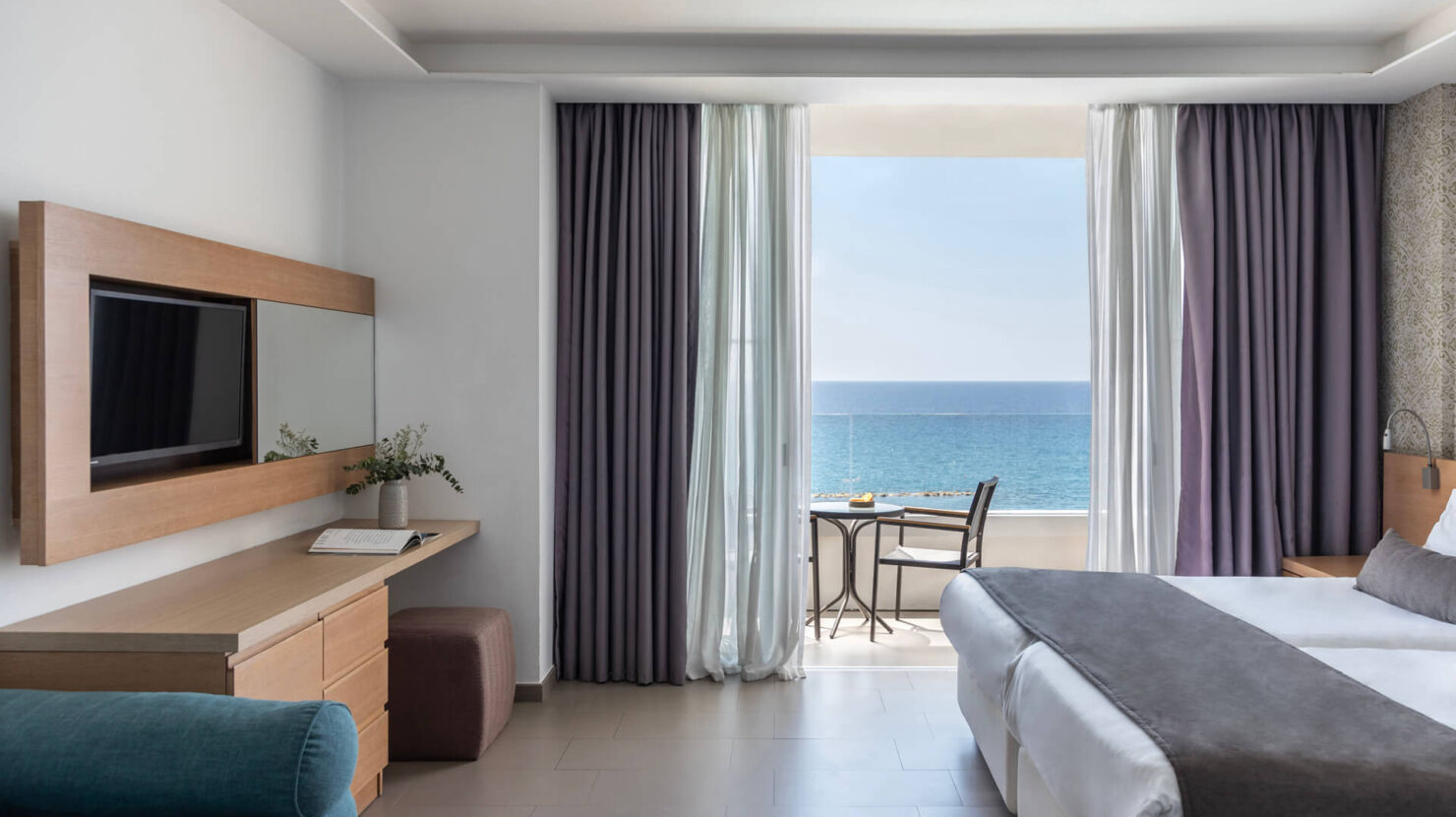 Royal Apollonia Family room bedroom and sitting area with balcony with sea view