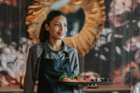 Waiter serving sushi at Royal Apollonia restaurant