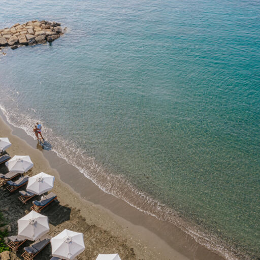 Couple walk at Royal Apollonia beach