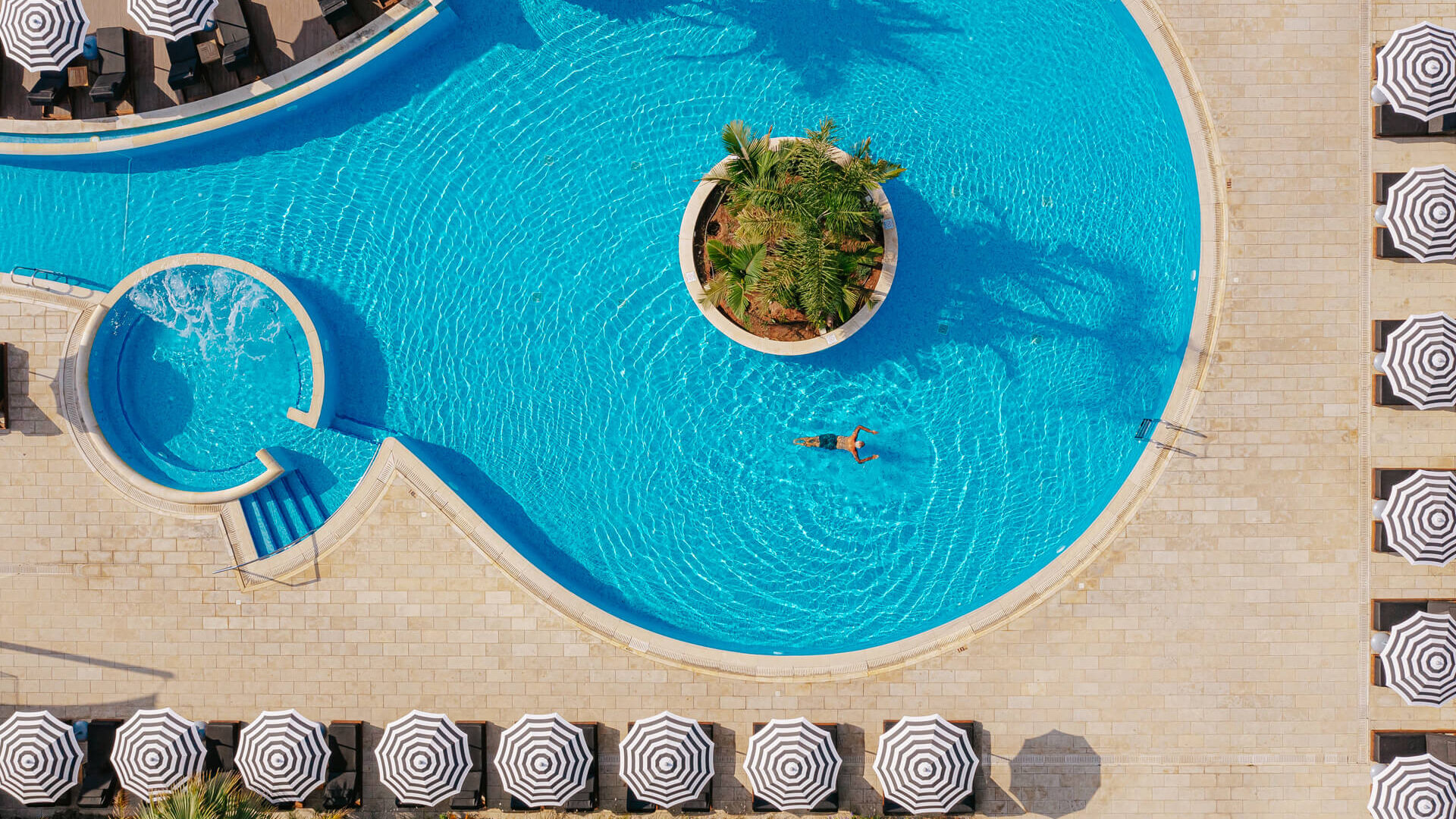 Man swimming at Royal Apollonia pool