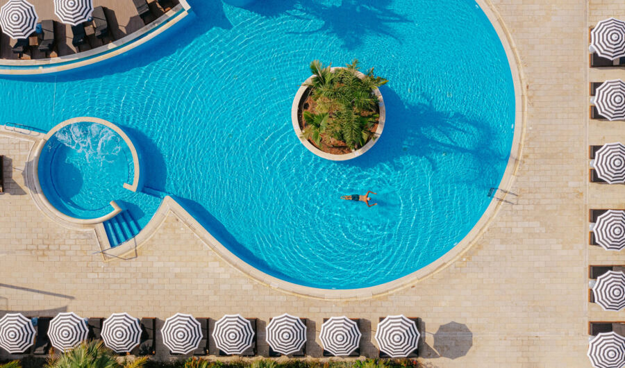 Man swimming at Royal Apollonia pool