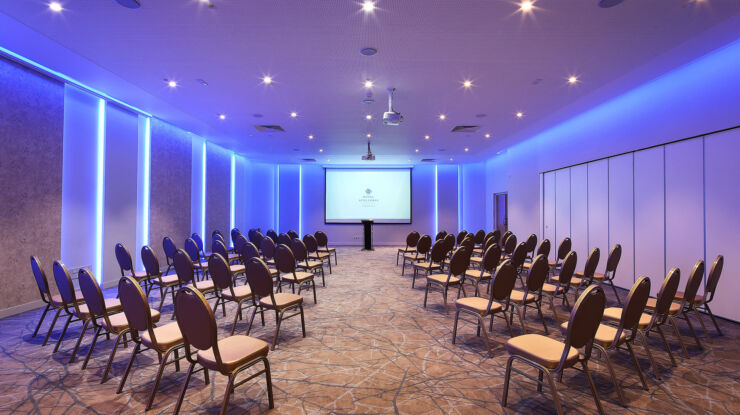 Royal Apollonia presentation room with projector and chairs