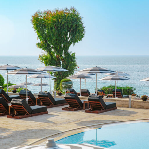 Royal Apollonia pool with sunbeds and sea view