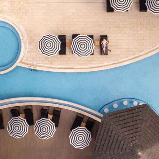 Woman sunbathing at Royal Apollonia pool