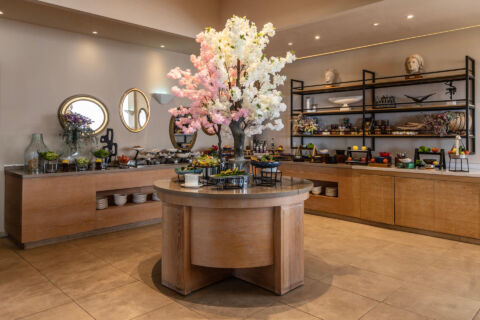 Buffet with a plant in the middle of the restaurant at Royal Apollonia