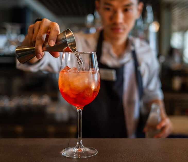 Bartender making cocktail at Royal Apollonia bar