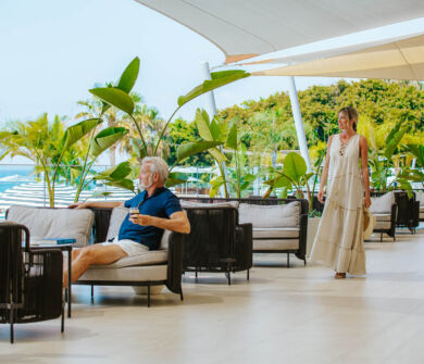 Man relaxing drinking coffee and woman walking at outdoor space at Royal Apollonia