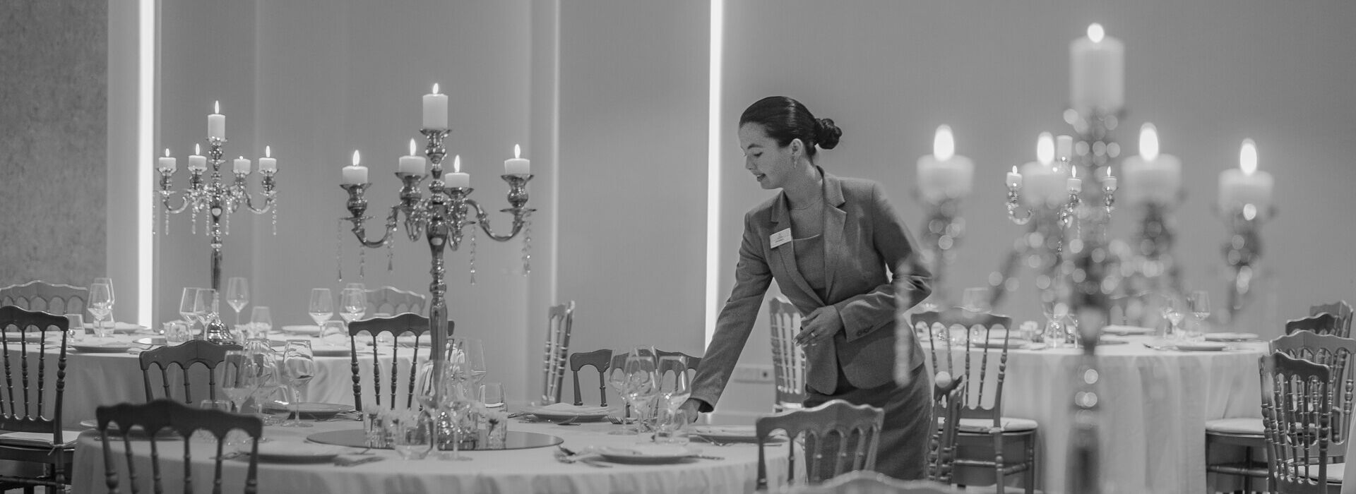 Hotel personnel preparing tables for formal meeting at Royal Apollonia