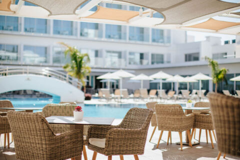 Outdoor Tables and pool at Sofianna Resort