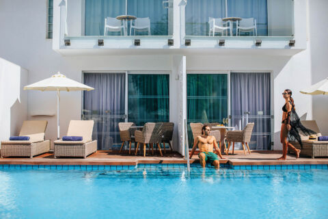 Couple relaxing outside room with swim pool at Outdoor Tables and pool at Sofianna Resort