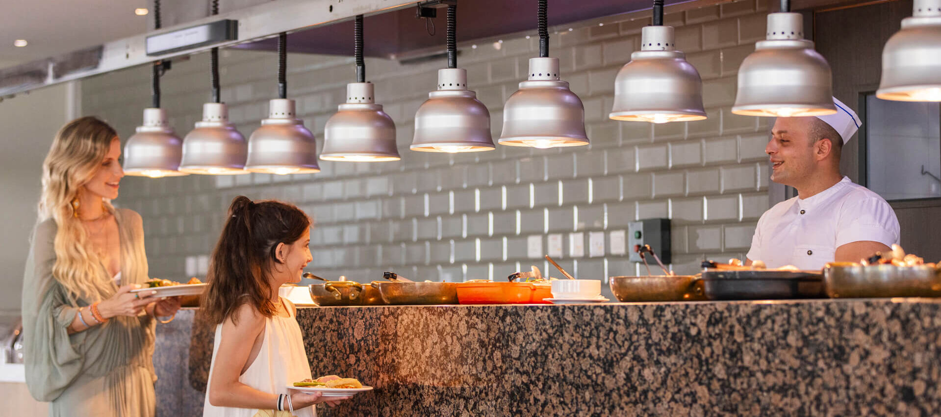 Kid talking to a cook at Sofianna Elea restaurant