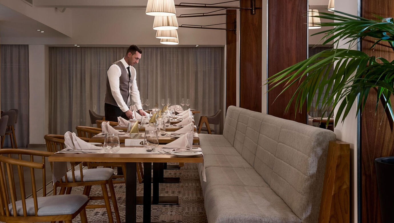 Waiter preparing tables at Sofianna Resort Mesogios A la Carte Restaurant