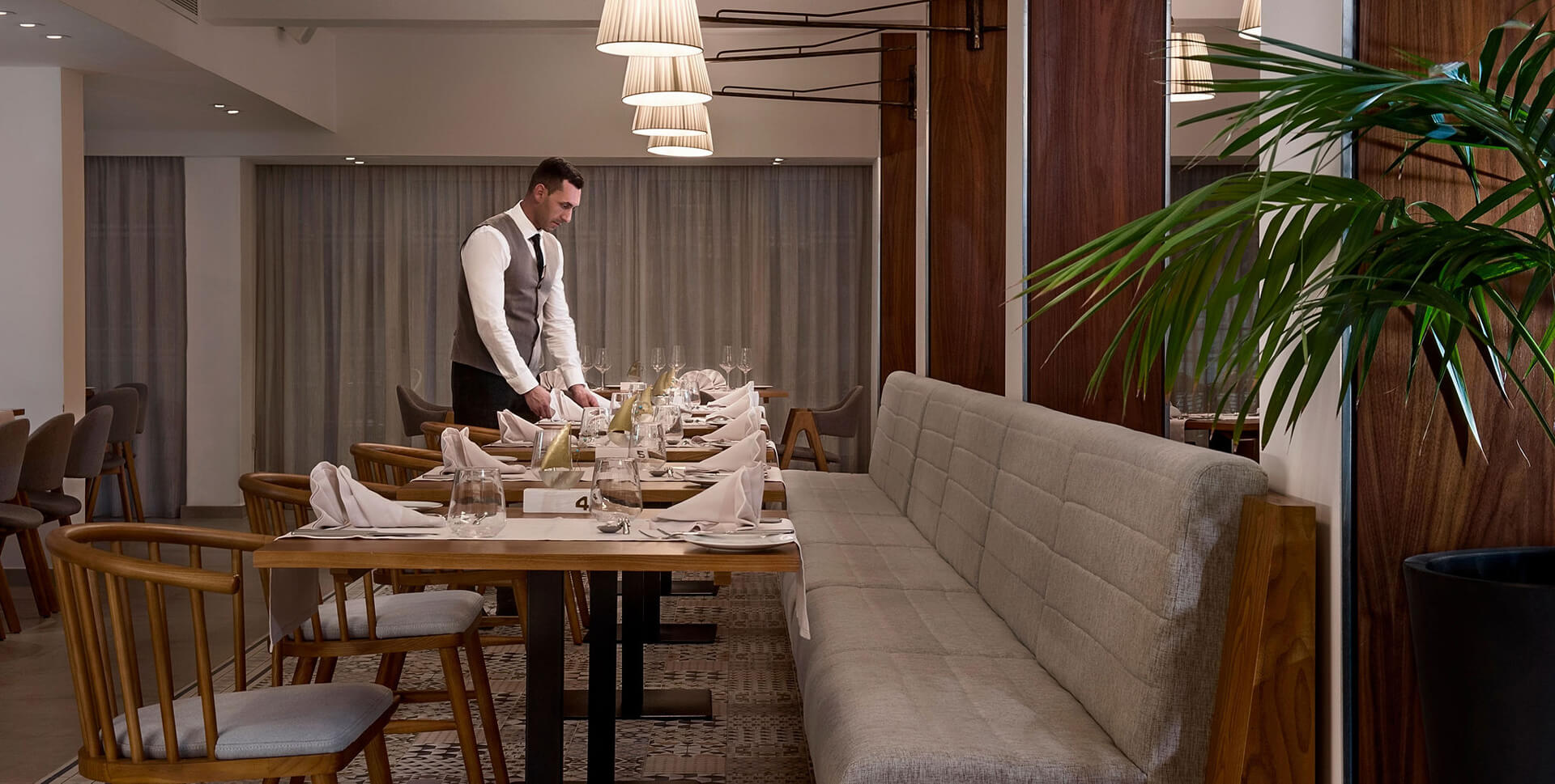 Waiter preparing tables at Sofianna Resort Mesogios A la Carte Restaurant
