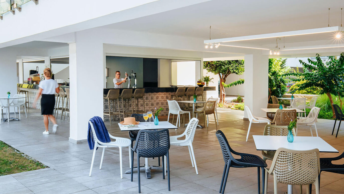 Sofianna Resort Thalassa restaurant bar and tables , staff pouring beer