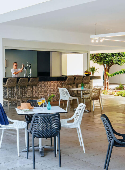 Sofianna Resort Thalassa restaurant bar and tables , staff pouring beer