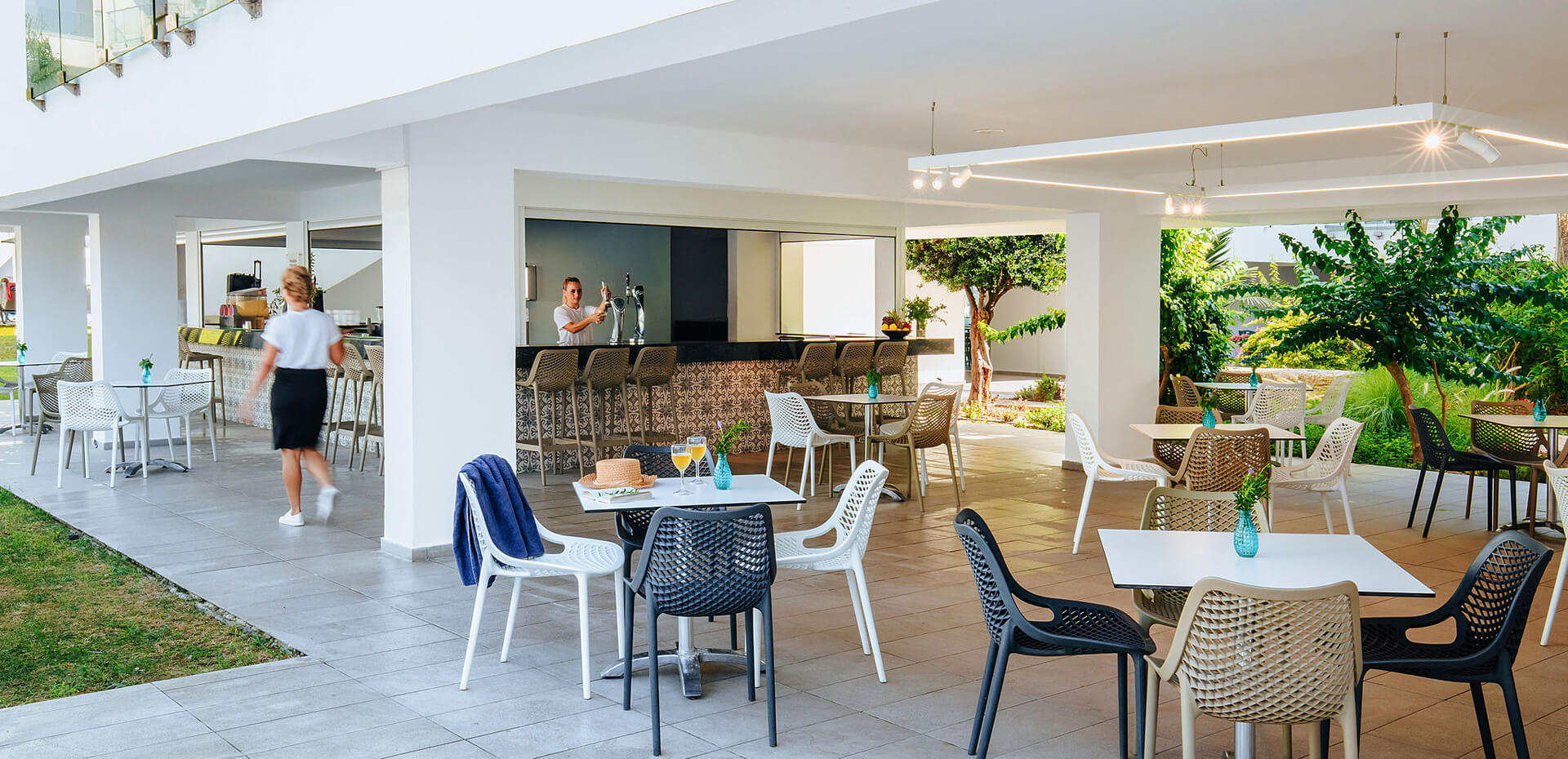 Sofianna Resort Thalassa restaurant bar and tables , staff pouring beer