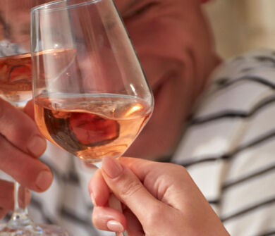 Two people drinking rose wine while laughing