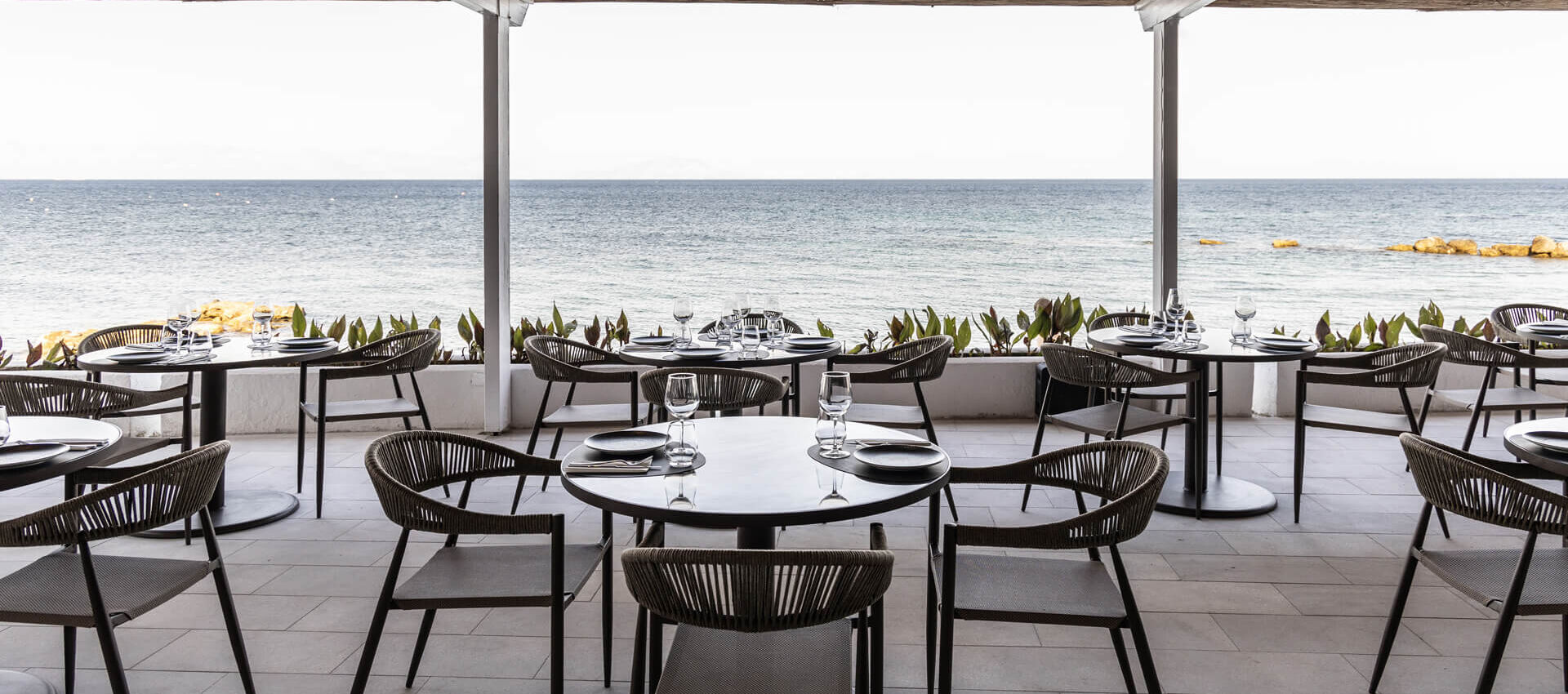Valmar Corfu Gill Restaurant outdoor terrace with tables and chairs with sea view