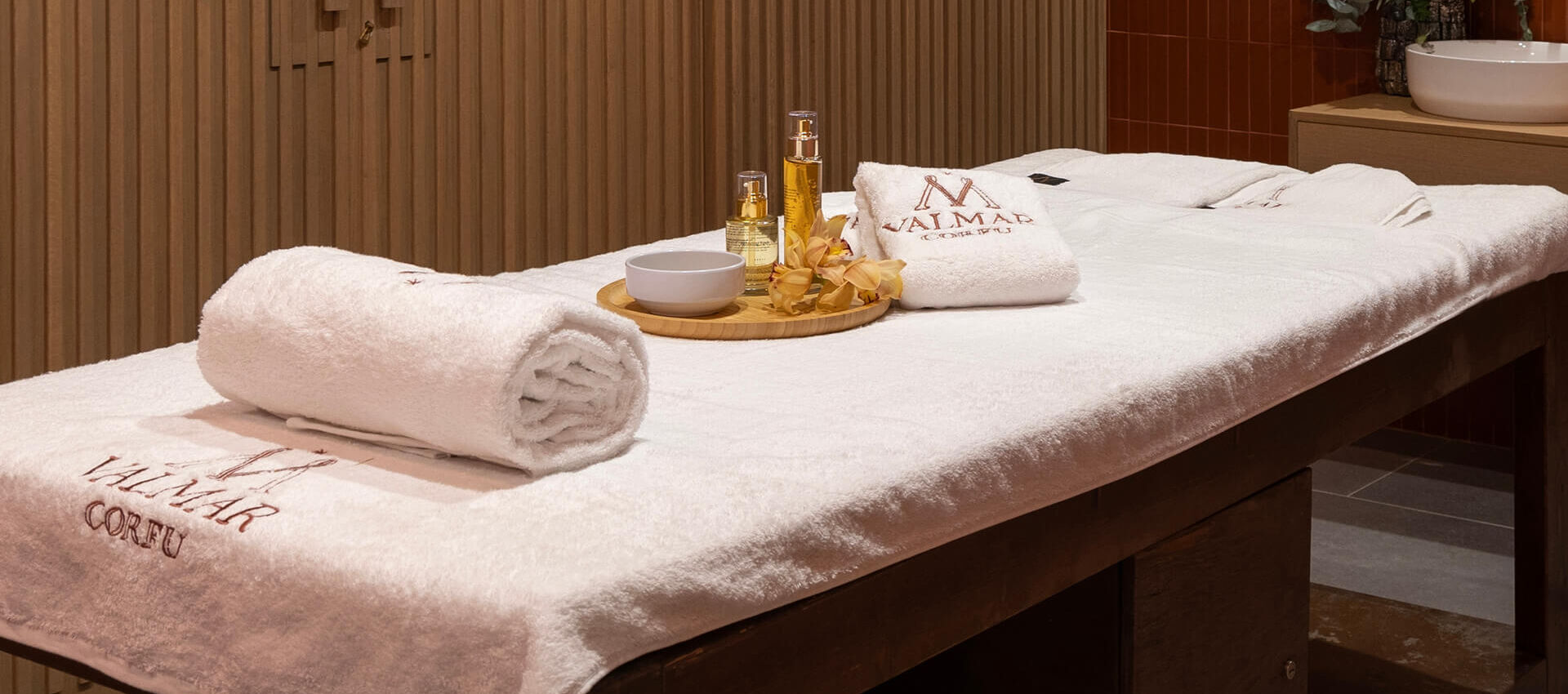 Massage bed prepared with towels and oils at Valmar Corfu Spa