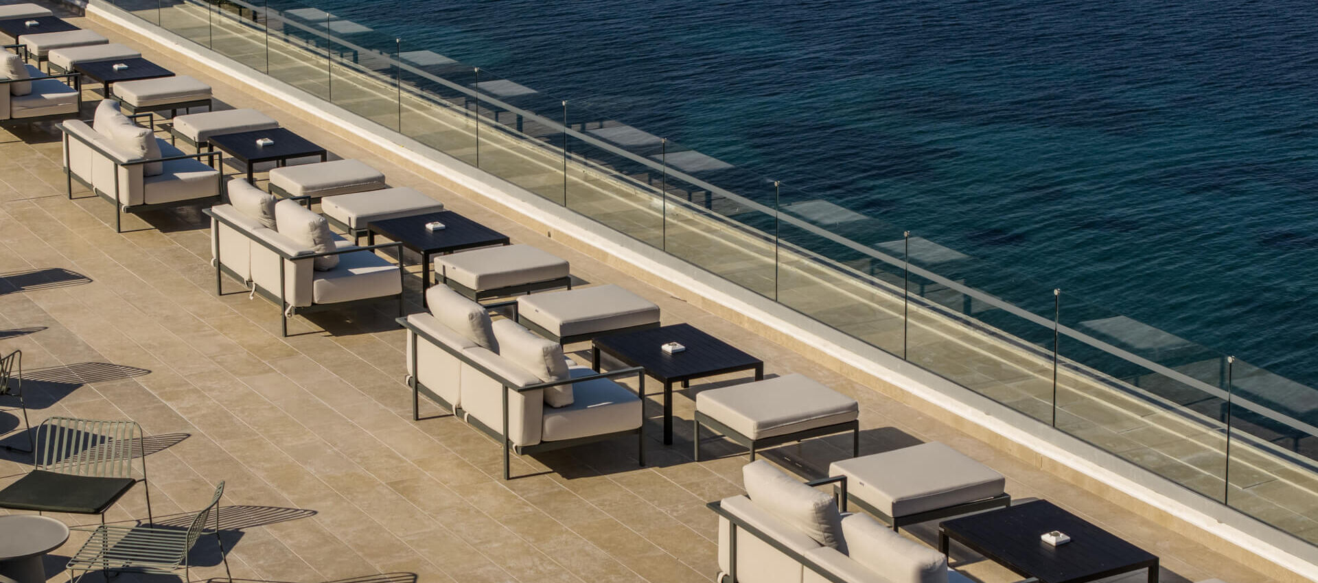 Rooftop tables and couch at tarazza restaurant at Valmar Corfu