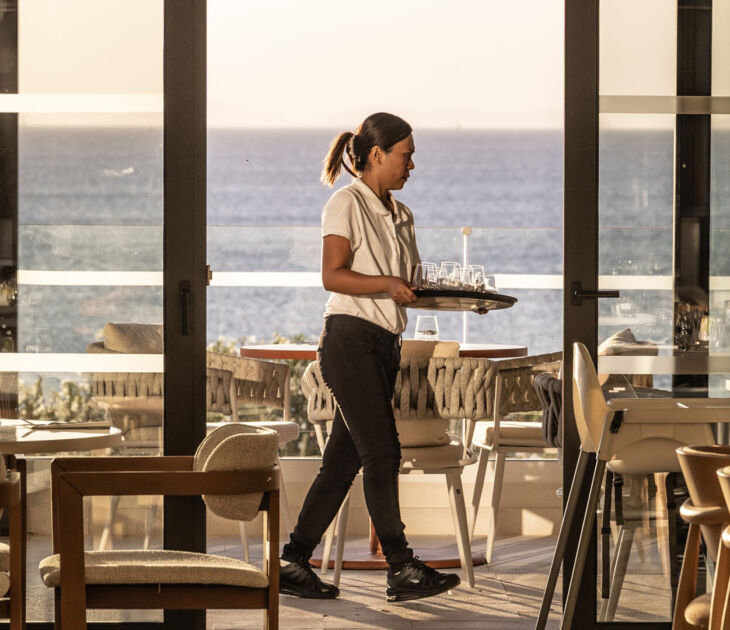 Waiter preparing tables for lunch at Valmar Corfu