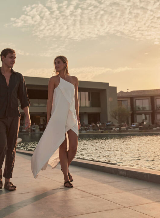 Couple walking near pool at Sunset