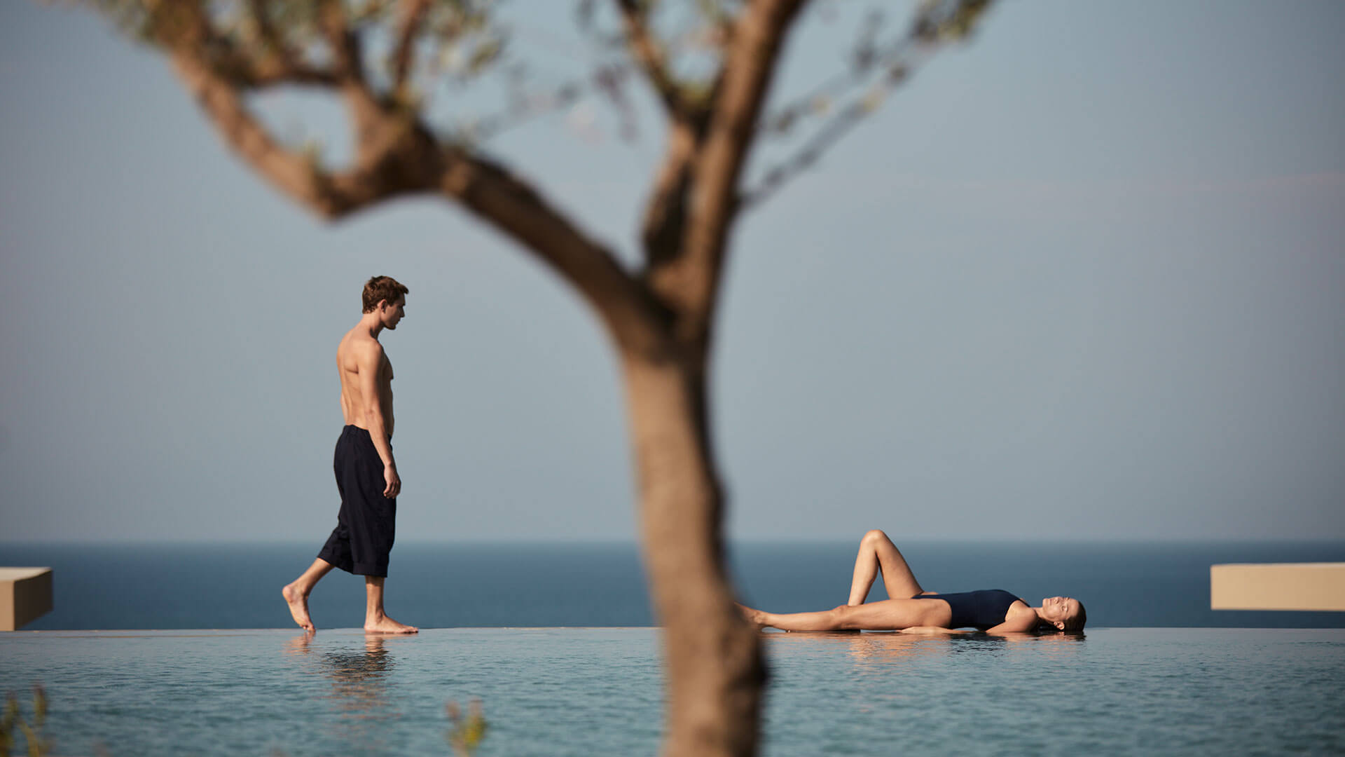 Couple at Zakynthos hotel pool with sea view